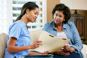 caregiver discussing records with elderly woman