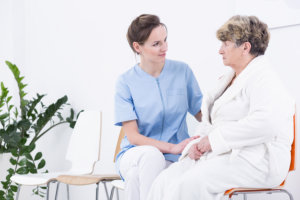 caregiver and elderly woman having conversation